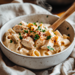 Cajun chicken pasta in white bowl with creamy sauce and parsley